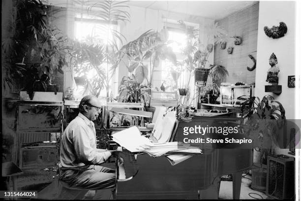 View of American composer Virgil Thompson as he plays piano in his apartment at the Chelsea Hotel, New York, New York, 1965.
