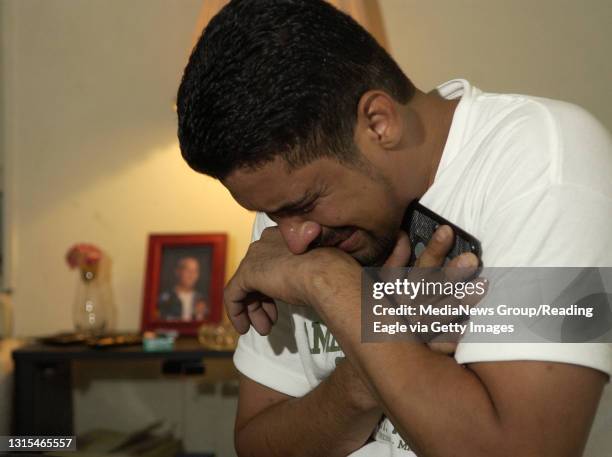 Photo by Krissy Krummenacker, Jose C. Fernandez sobs while clutching a photograph of his brother Spc. William Fernandez Tuesday, September 20 who was...