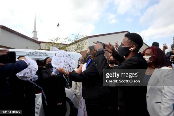 Family members release butterflies next to the hears carrying the remains of 16-year-old Ma'Khia Bryant following her funeral service at First Church...