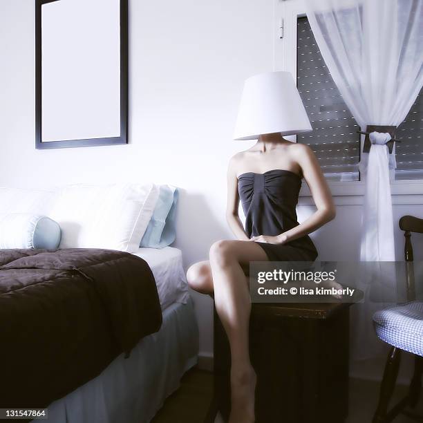 young woman wearing lamp shade on head - lamp shade stockfoto's en -beelden