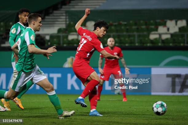 Hwang Hee-chan of RB Leipzig scores his team's first goal during the DFB Cup semi final match between Werder Bremen and RB Leipzig at Weserstadion on...