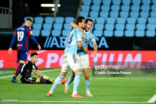 Augusto Solari of Celta Vigo celebrates with a team mate after scoring his team's second goal during the La Liga Santander match between RC Celta and...