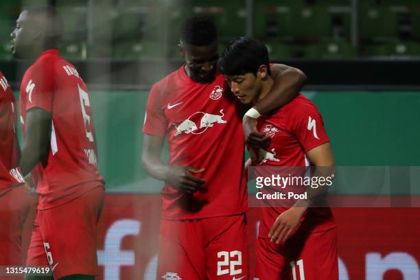 Hwang Hee-chan of RB Leipzig celebrates with Nordi Mukiele after scoring his team's first goal during the DFB Cup semi final match between Werder...