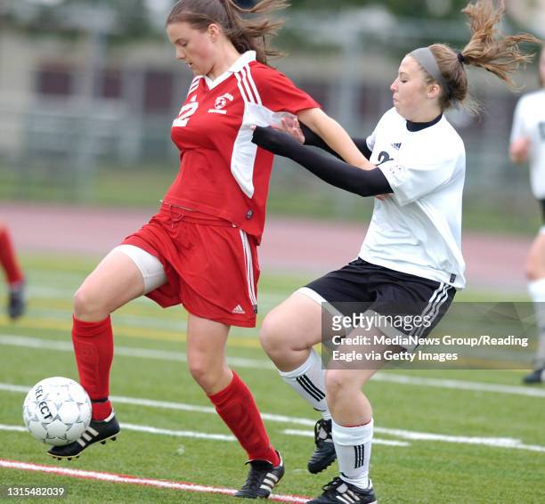 Photo by Krissy Krummenacker 200800727 Fleetwood's Jackie Buss battles to keep the ball from Lancaster Mennonite's Joanna Cotee Tuesday, May 20 in...