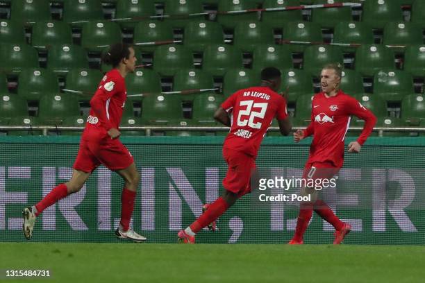 Emil Forsberg of RB Leipzig celebrates with team mate Nordi Mukiele after scoring his team's second goal during the DFB Cup semi final match between...
