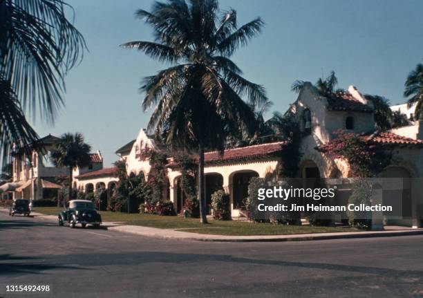 35mm film photo shows a large, Spanish-style house in an upper class residential neighborhood in Palm Beach, Florida, 1939.