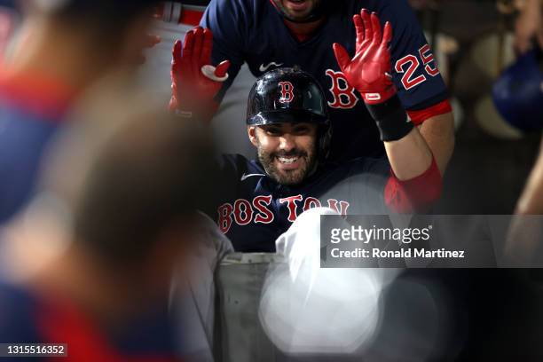 Martinez of the Boston Red Sox is pushed in a laundry cart after hitting a three-run homerun against the Texas Rangers in the first inning at Globe...