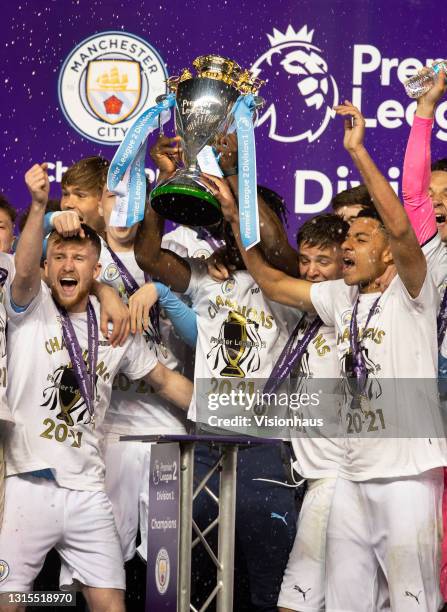 Conrad Egan Riley, James McAtee, Liam Delap, Tommy Doyle and Romeo Lavia of Manchester City celebrate with the Premier League 2 trophy after the...