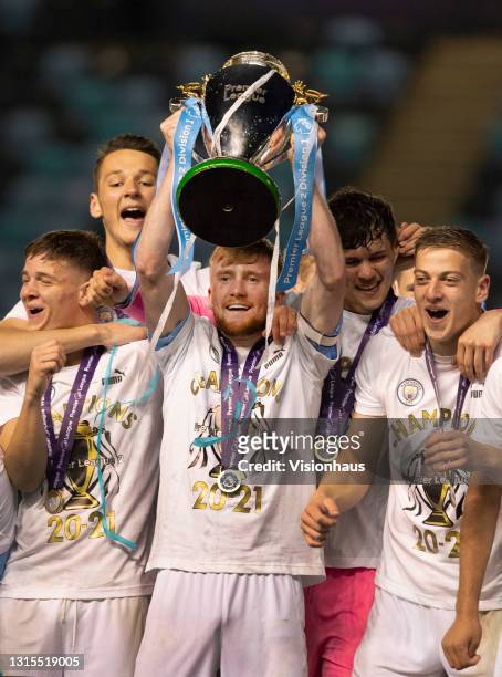 James McAtee, Tommy Doyle, Liam Delap, Cieran Slicker and James Trafford of Manchester City celebrate with the Premier League 2 trophy after the...