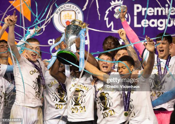 Conrad Egan Riley, James McAtee, Liam Delap, Cieran Slicker, Tommy Doyle and Romeo Lavia of Manchester City celebrate with the Premier League 2...