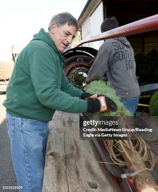 Blake Ruffner Rick Minicozzi, left and Sam Ruffner run this tree through a machine ...