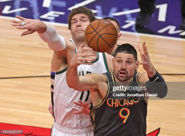 Nikola Vucevic of the Chicago Bulls and Brook Lopez of the Milwaukee Bucks battle for a rebound at the United Center on April 30, 2021 in Chicago,...