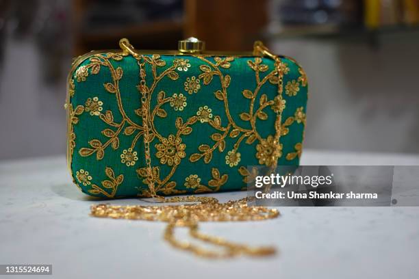 designer party wear clutch hang bag with golden embroidery and sequin work. - designer handbag stockfoto's en -beelden
