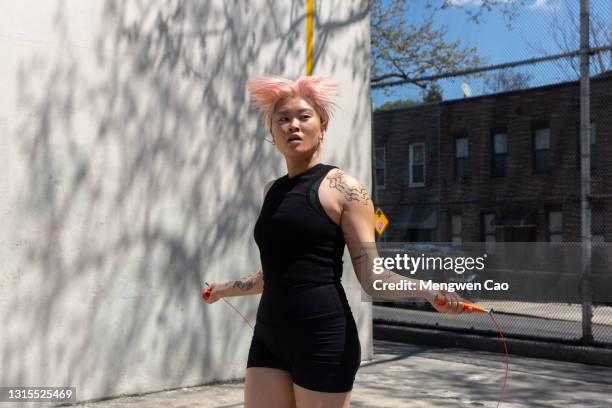 non-binary queer person jumping rope - showus fitness stock pictures, royalty-free photos & images