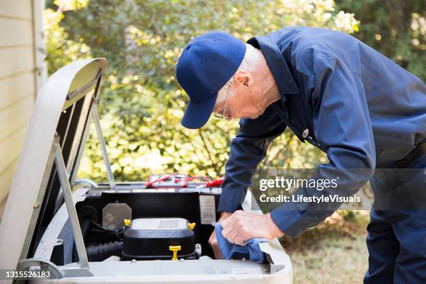 technician services outside ac units and generator. - gerador imagens e fotografias de stock