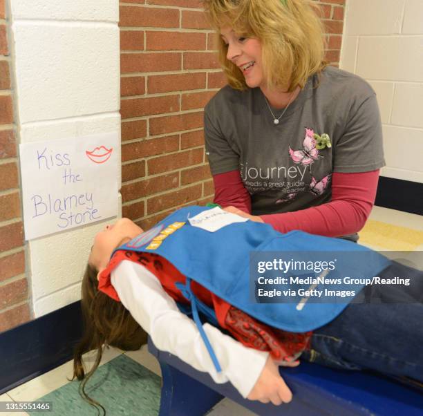 Photo by Tim Leedy 2/23/13Girl Scout Thinking Day at Conrad Weiser middle school..Savannah Rizzo learns how the Irish kiss the Blarney Stone with the...