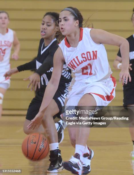Wilson's Avery Marz moves the ball around Harrisburg's Alexis Marshall .Girls basketball, the Harrisburg Cougars vs the Wilson Bulldogs at Wilson...