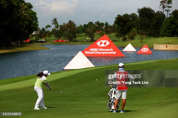 Inbee Park of South Korea plays her second shot from the fifth fairway as her husband and caddie Gi Hyeob Nam looks on during the third round of the...