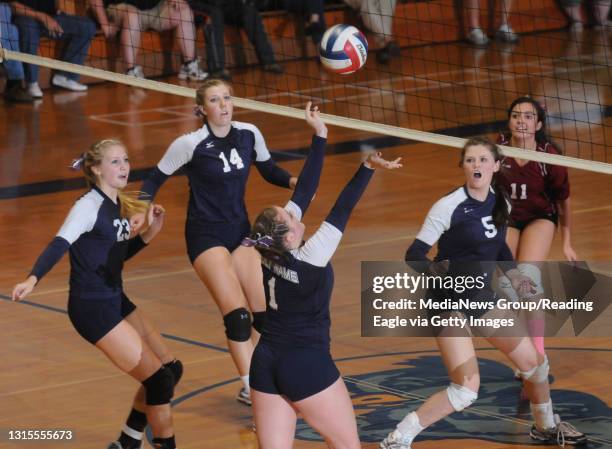 Reading, PAHoly Name's Tori Hutchinson sets the ball as her teammates from left: Macy Bosshard , Erin Noga , and Rachael Burke look on. Watching from...