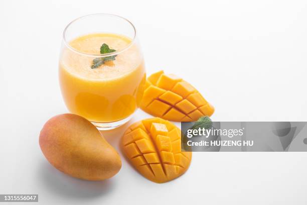 fresh tropical fruit smoothie mango juice. glass of mango juice. - mango juice stock-fotos und bilder