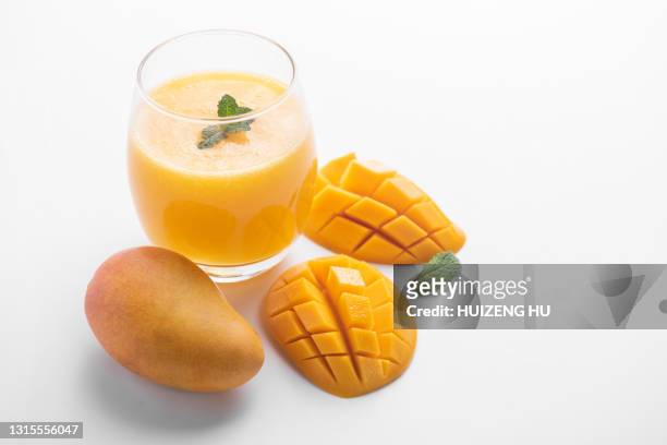 fresh tropical fruit smoothie mango juice. glass of mango juice. - mango juice stockfoto's en -beelden