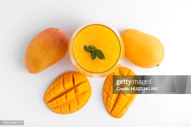 fresh mango smoothie in the glass. top view. glass of mango juice. - mango juice stock-fotos und bilder