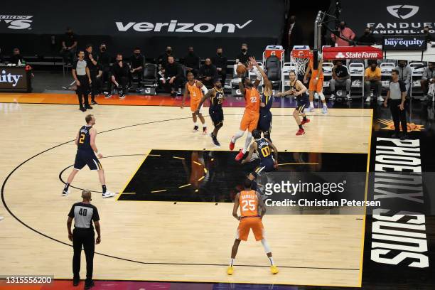Deandre Ayton of the Phoenix Suns puts up a shot over Rudy Gobert of the Utah Jazz during the second half of the NBA game at Phoenix Suns Arena on...