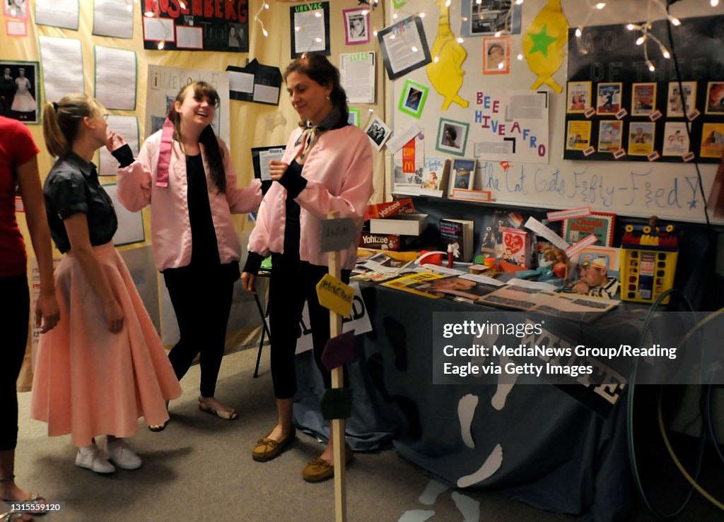 From left, senior Kathleen Kiger, 18, junior Helen Reinbrecht, 16, and junior Maddie Wagner, 17, portray doo-wop girls in a poodle skirt and pink coats from the 50's era.Wilson High's AP history class works on a project studying the 1950's - 80's wit