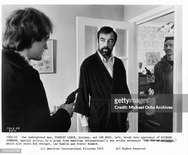 Ian Hogg , and Stanley Lebor break into the apartment of Richard Johnson in a scene from the film 'Hennessy', 1975.