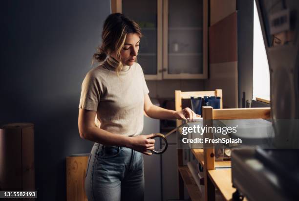 moving out: young woman packing things in her kitchen - belongings stock pictures, royalty-free photos & images