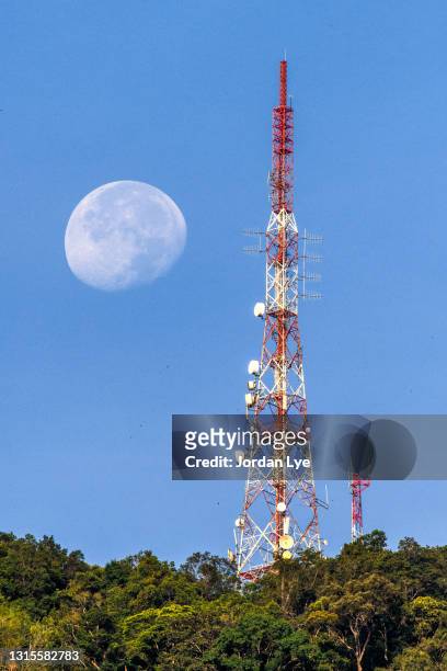 moon with blue sky and telecommunication tower - microwave tower stock pictures, royalty-free photos & images