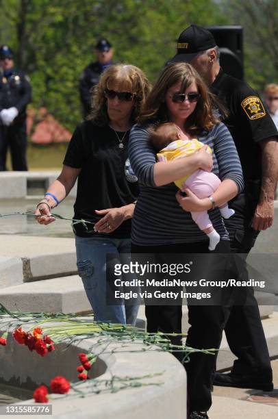 Photo Ryan McFadden Fraternal Order of Police Memorial Service at the Heritage Center; from left is Michelle Moyer, Kyle Pagerly's mom and Alecia and...