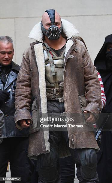 Actor Tom Hardy is seen in costume as Bane on the set of "The Dark Knight Rises" on location on Wall Street on November 5, 2011 in New York City.