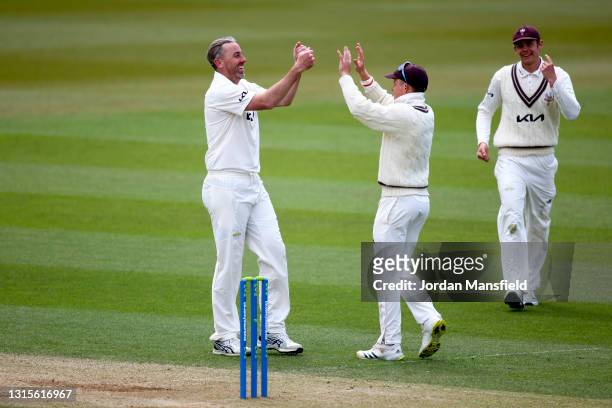 Rikki Clarke and Ollie Pope of Surrey celebrate dismissing Joe Weatherley of Hampshire during day three of the LV= Insurance County Championship...