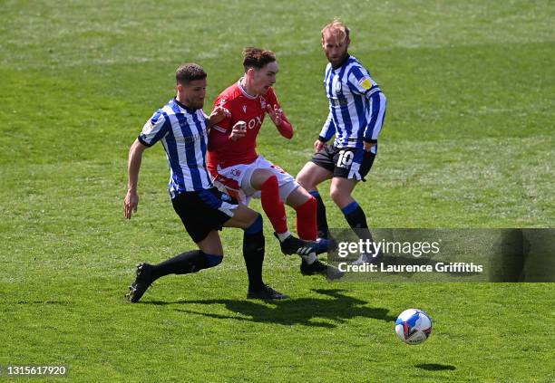 James Garner of Nottingham Forest is challenged by Sam Hutchinson of Sheffield Wednesday during the Sky Bet Championship match between Sheffield...