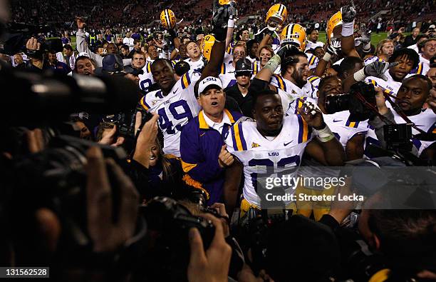 Head coach Les Miles of the LSU Tigers celebrates with his team after defeating the Alabama Crimson Tide 9-6 in overtime at Bryant-Denny Stadium on...