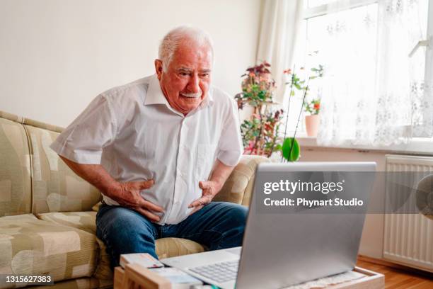 sick senior patient having aching belly,hands hold stomach,stomachache,old people with symptoms gastrointestinal system disease,crampy abdominal pain hurt in stomach caused by indigestion or diarrhoea - colon cancer stock pictures, royalty-free photos & images