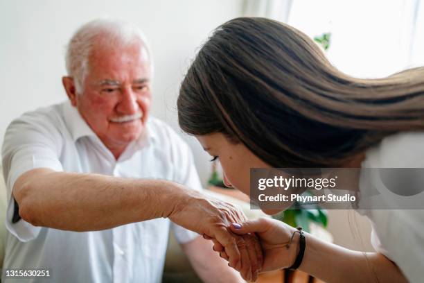 kissing grandfather’s hand, celebration islamic event - kissing hand stock pictures, royalty-free photos & images