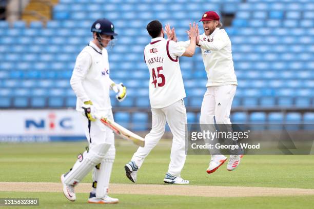 Wayne Parnell of Northamptonshire celebrates with team mate Gareth Berg after taking the wicket of Harry brook of Yorkshire during the LV= Insurance...