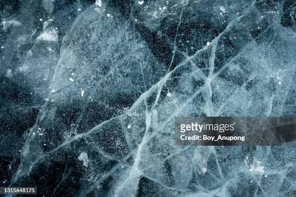 beautiful cracks surface of the frozen lake of baikal lake with frost methane bubbles in winter season. - frosty ストックフォトと画像