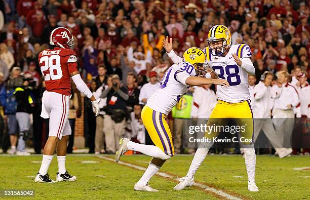 Drew Alleman of the LSU Tigers celebrates after kicking the game-winning field goal in overtime to defeat the Alabama Crimson Tide 9-6 at...