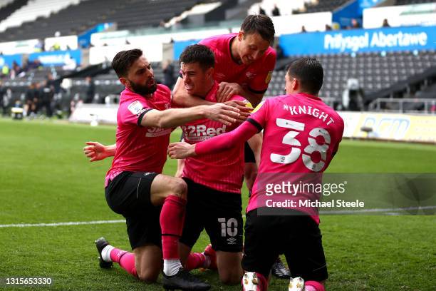 Tom Lawrence of Derby County celebrates with Graeme Shinnie and Jason Knight after scoring their team's first goal during the Sky Bet Championship...