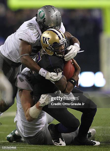 Quarterback Keith Price of the Washington Huskies is sacked by Taylor Hart of the Oregon Ducks on November 5, 2011 at Husky Stadium in Seattle,...