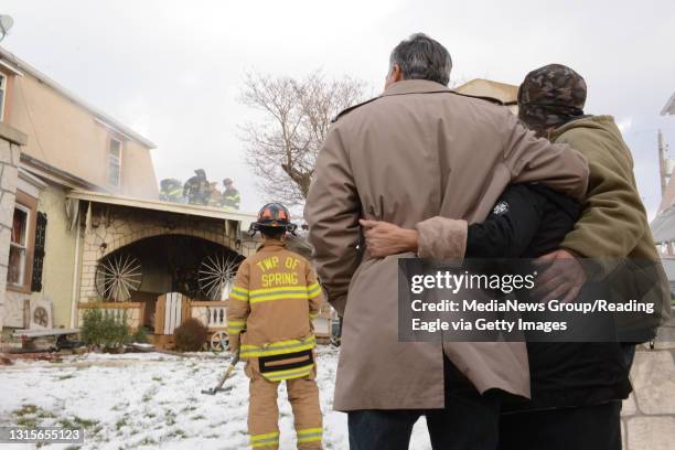 Photo Ryan McFadden Luzerne St fire; The family watches while crying etc. They wouldn't give their names, but admitted the parents live there and at...