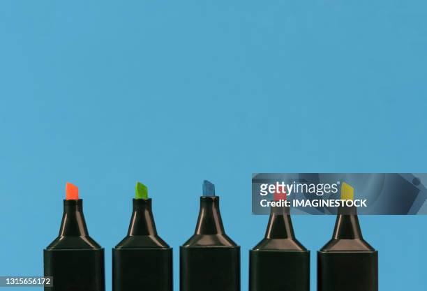 fluorescent markers of different colors on a blue background - highlights stock pictures, royalty-free photos & images