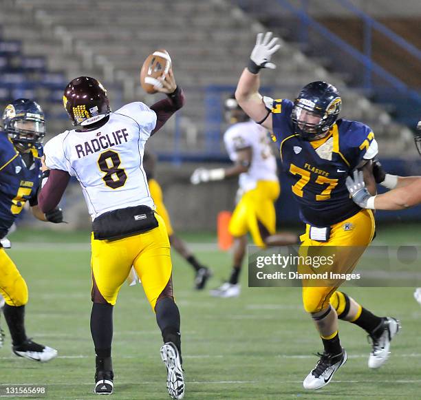 Defensive linemen Lee Stalker of the Kent State Golden Flashes puts pressure on quarterback Ryan Radcliff of the Central Michigan Chippewas during a...