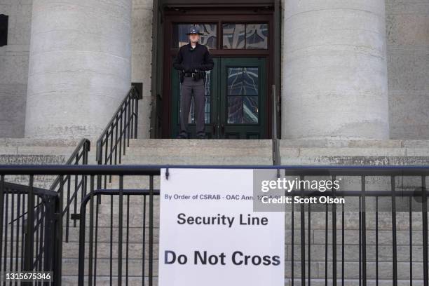 Police officer stands guard as demonstrators protest for and against the police outside of the Ohio Statehouse on May 01, 2021 in Columbus, Ohio. A...