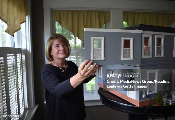 Jan Knudsen poses with her dollhouse in her Wyomissing home. Reading Eagle: Lauren A. Little Knudsen Dollhouse 6/21/2017