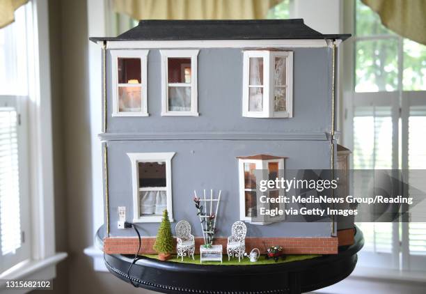 Side of dollhouse with small lawn vignette.Reading Eagle: Lauren A. Little Knudsen Dollhouse 6/21/2017