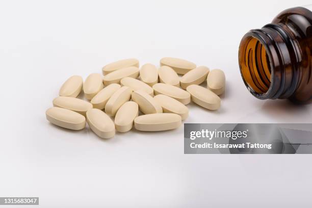 close up vitamins and supplements on white background with a brown bottle. including vitamin c, vitamin e, vitamin d3, salmon oil, fish oil and co enzyme q10 capsules. - doping pills stock pictures, royalty-free photos & images